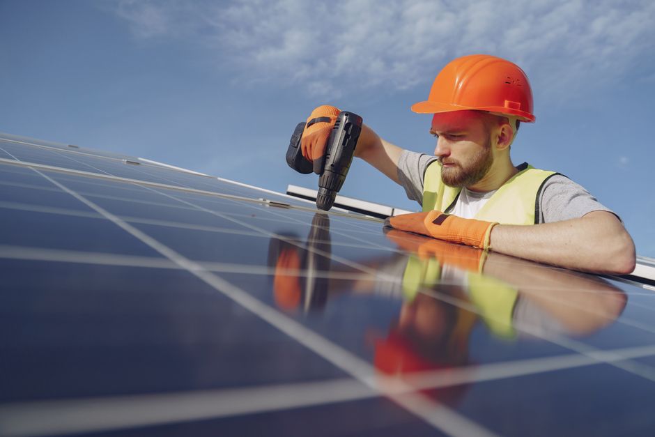 Solar installation professional working on a residential roof